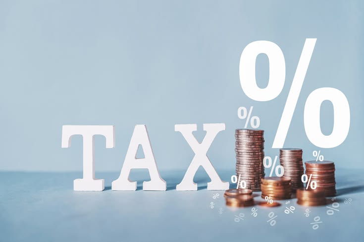 Tax Text Written On Wooden Block With Stacked Coins, Tax Concept